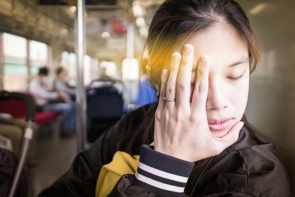 Girl on train fighting motion sickness