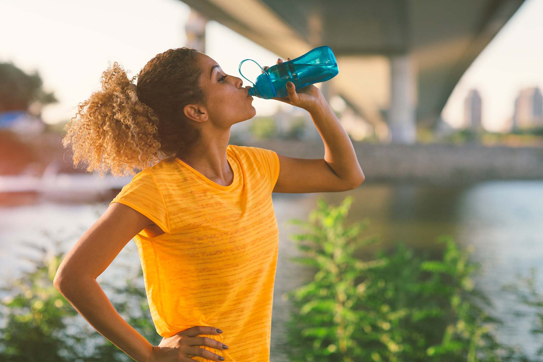 Woman drinks water after exercising