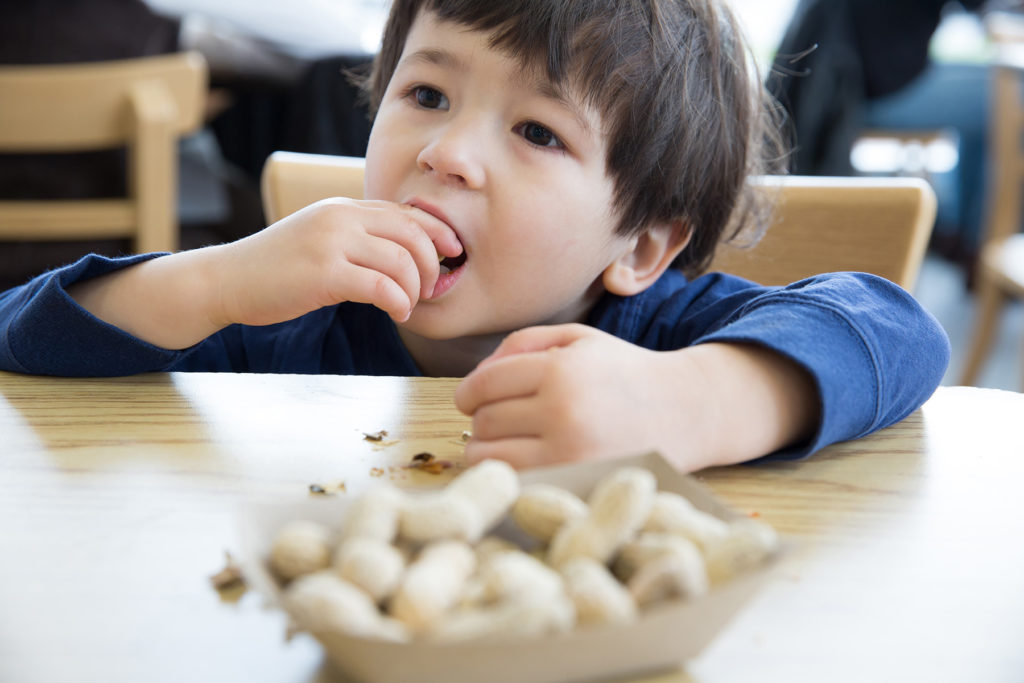 Little boy eating nuts