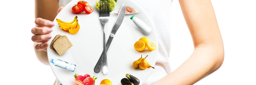 fasting - woman holding a clock