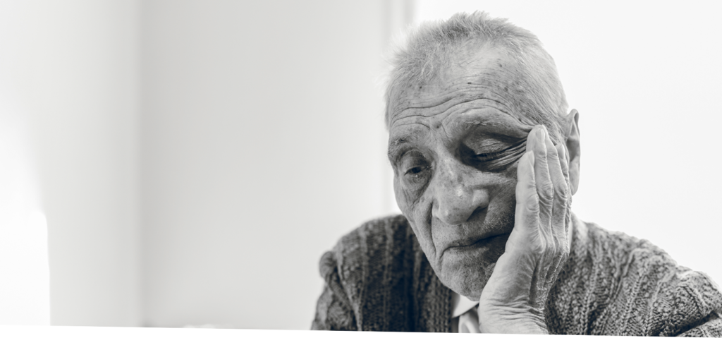 Black and white of elderly man face in hand