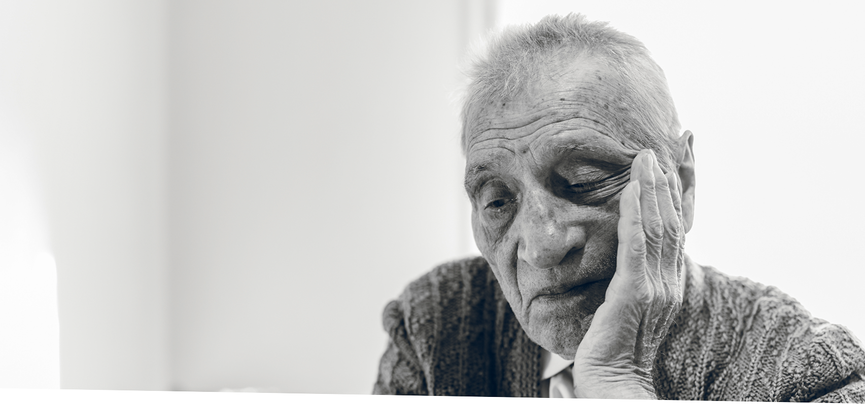 Black and white of elderly man face in hand