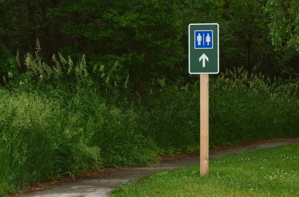 Bathroom sign in the woods