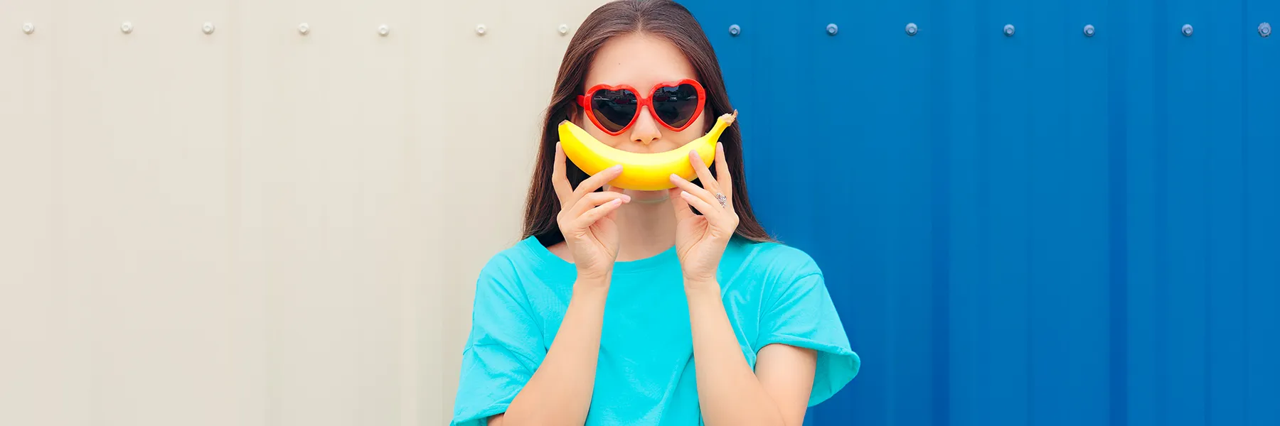 Girl holding a banana rich in potassium