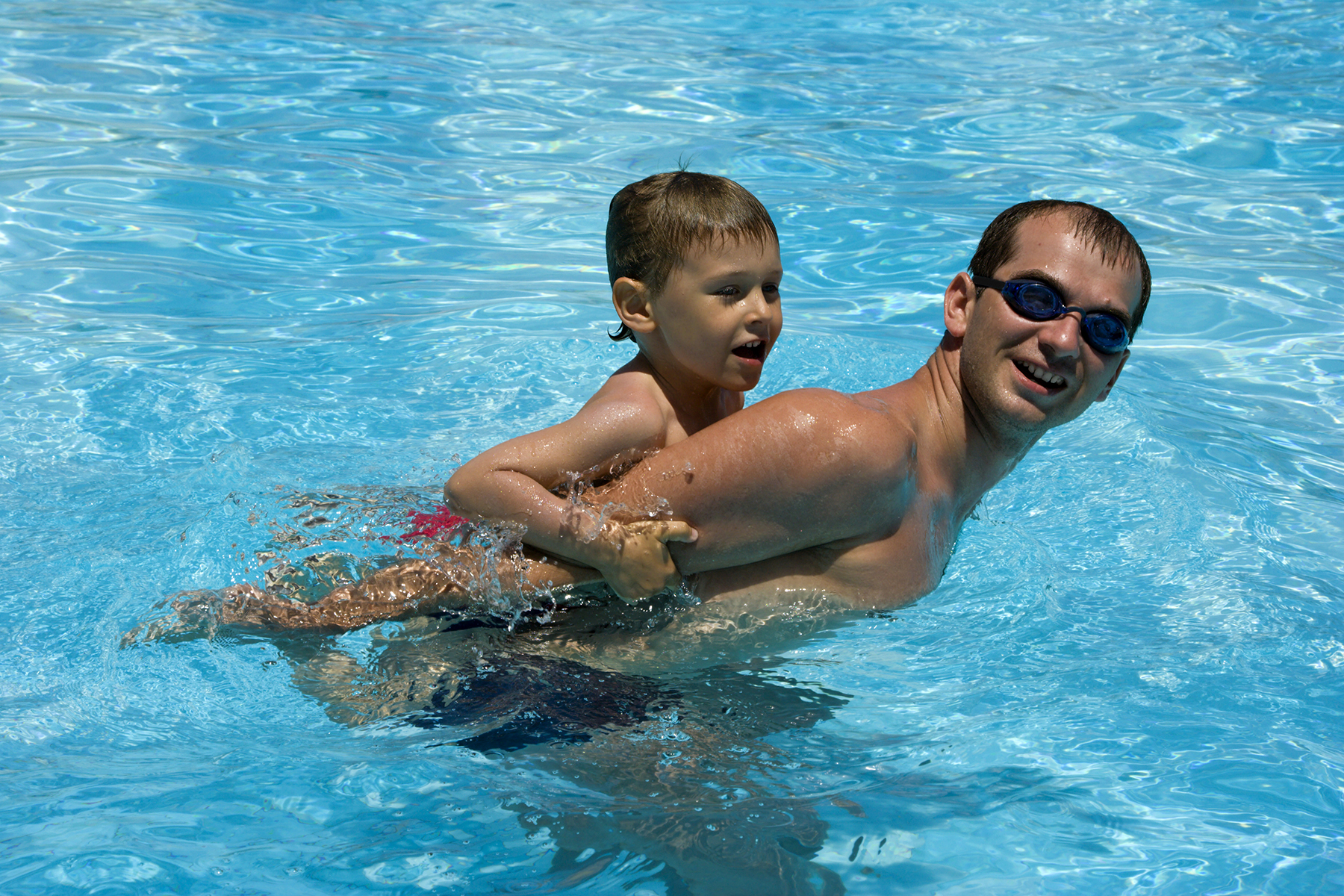 Dad and son in pool