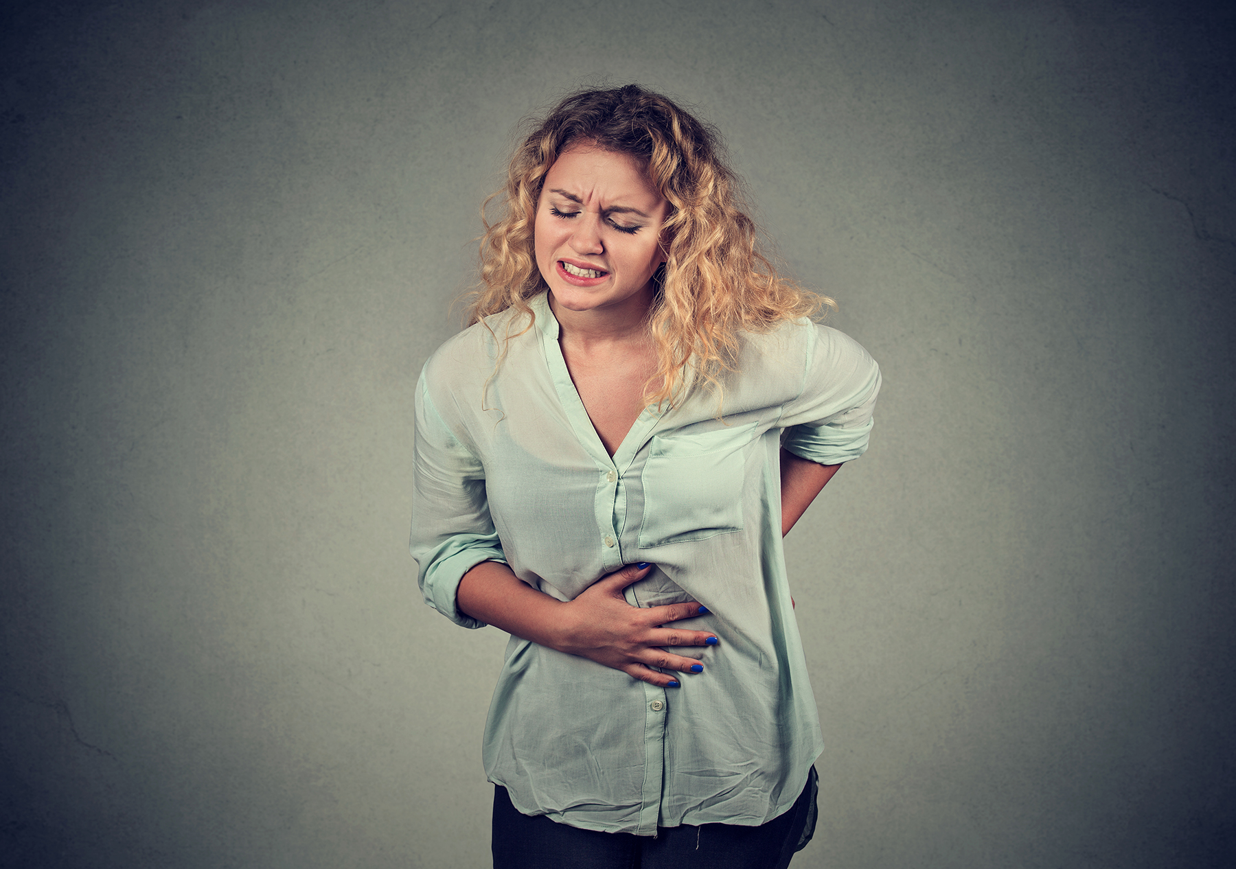 Woman holding stomach in pain