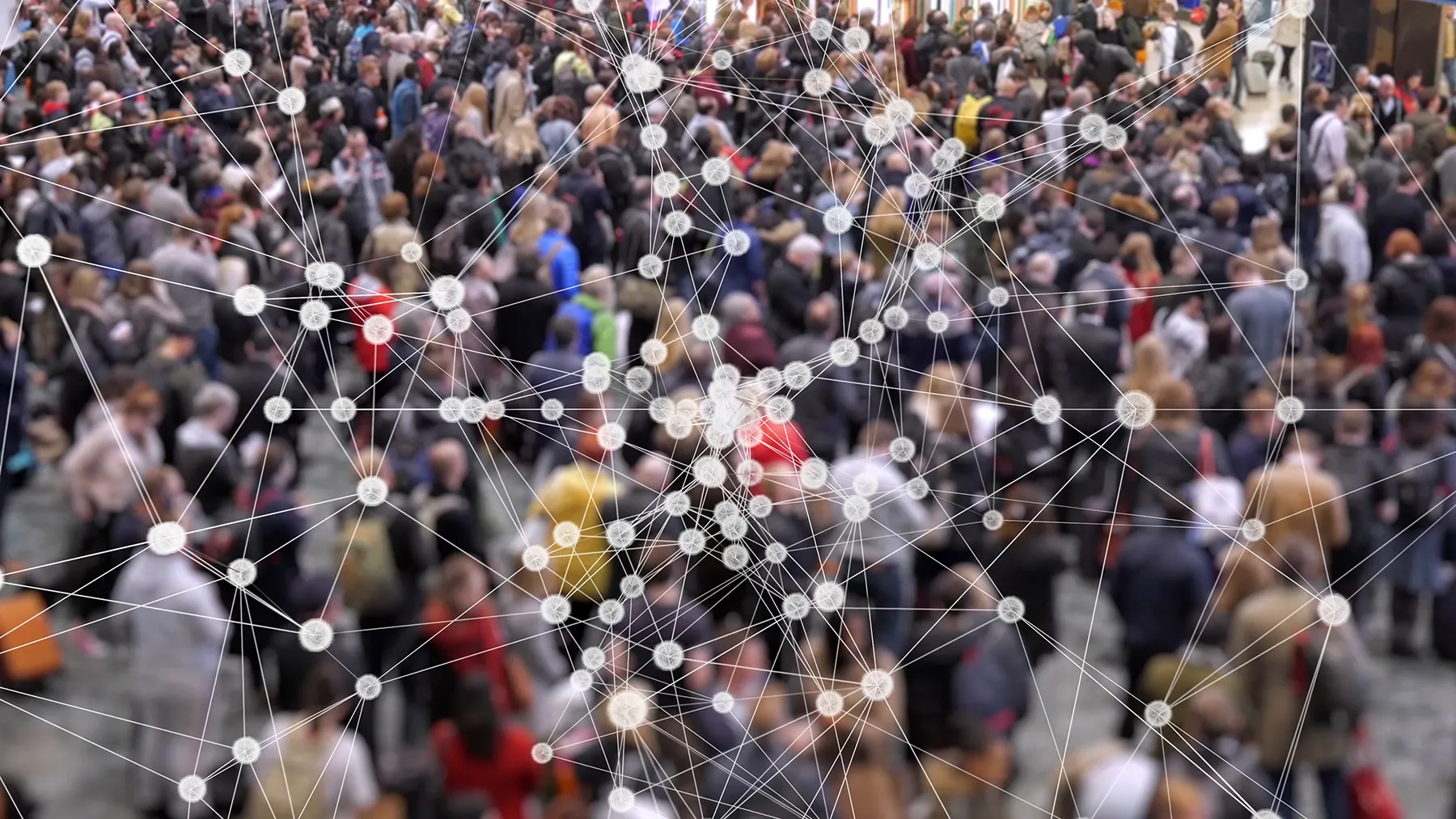 White network of lines and glowing nodes superimposed over a blurred, dense crowd of people, symbolizing interconnectedness, data, or social connections.