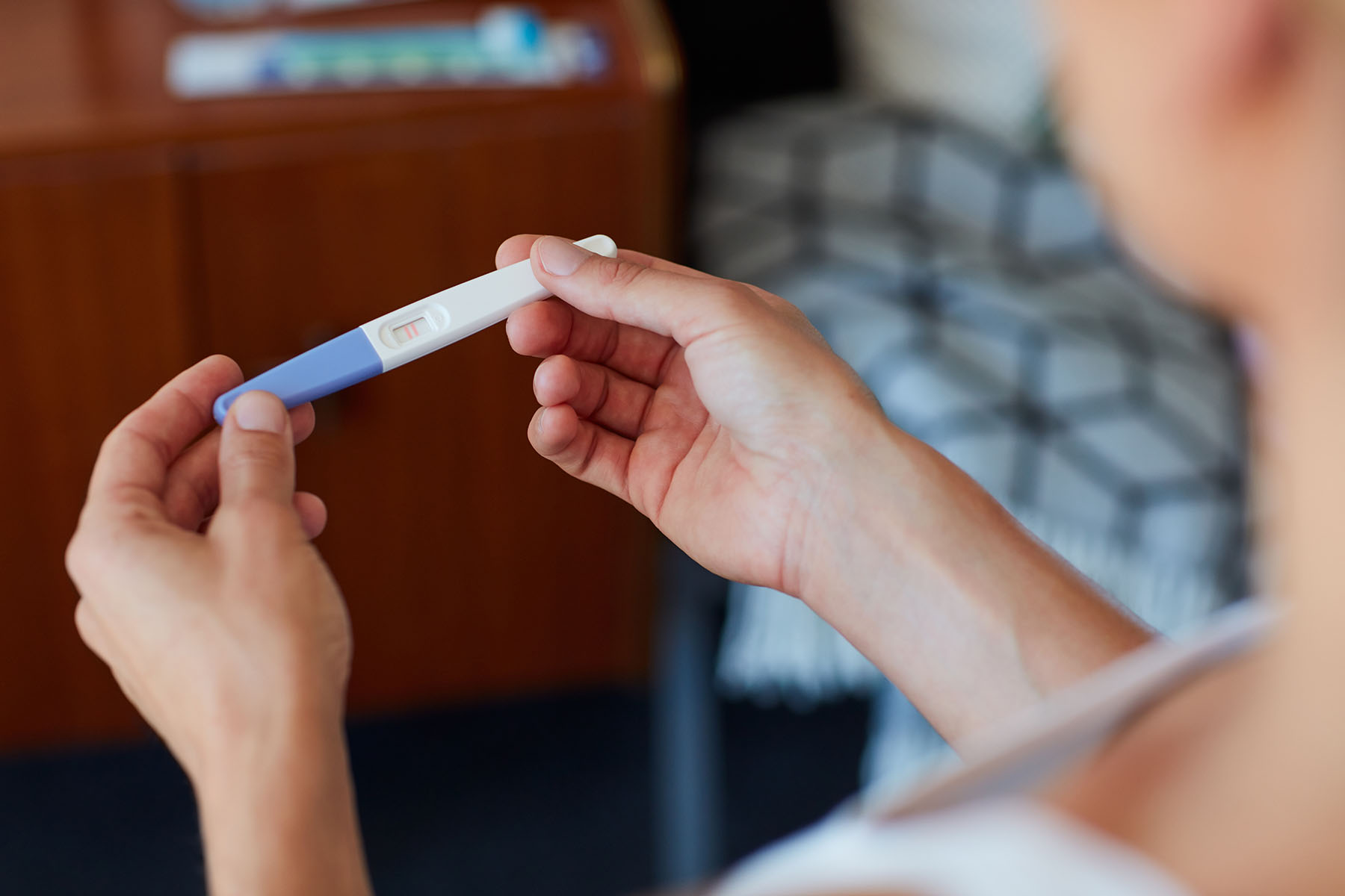 Woman holds pregnancy test
