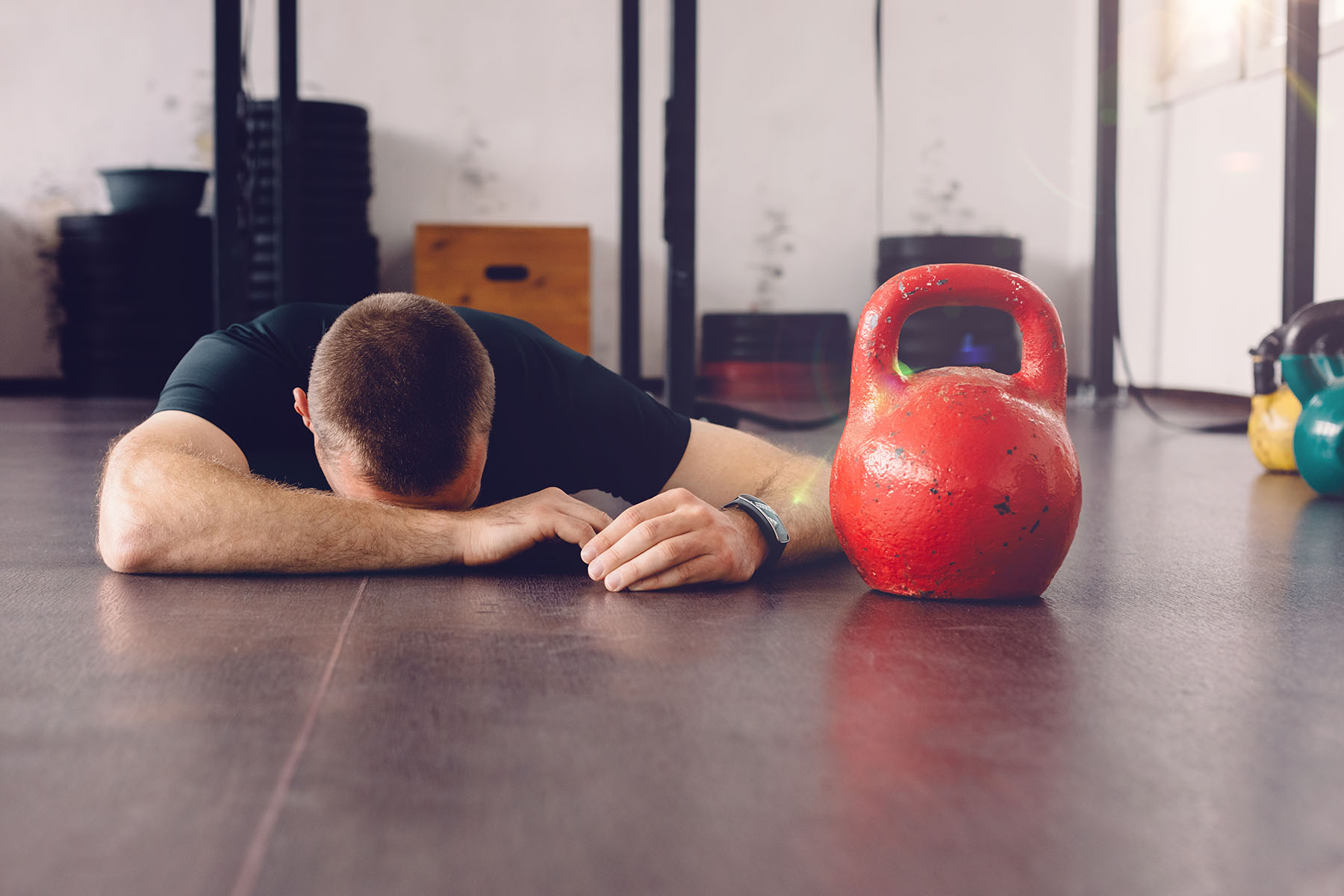 Exhausted man on floor of gym