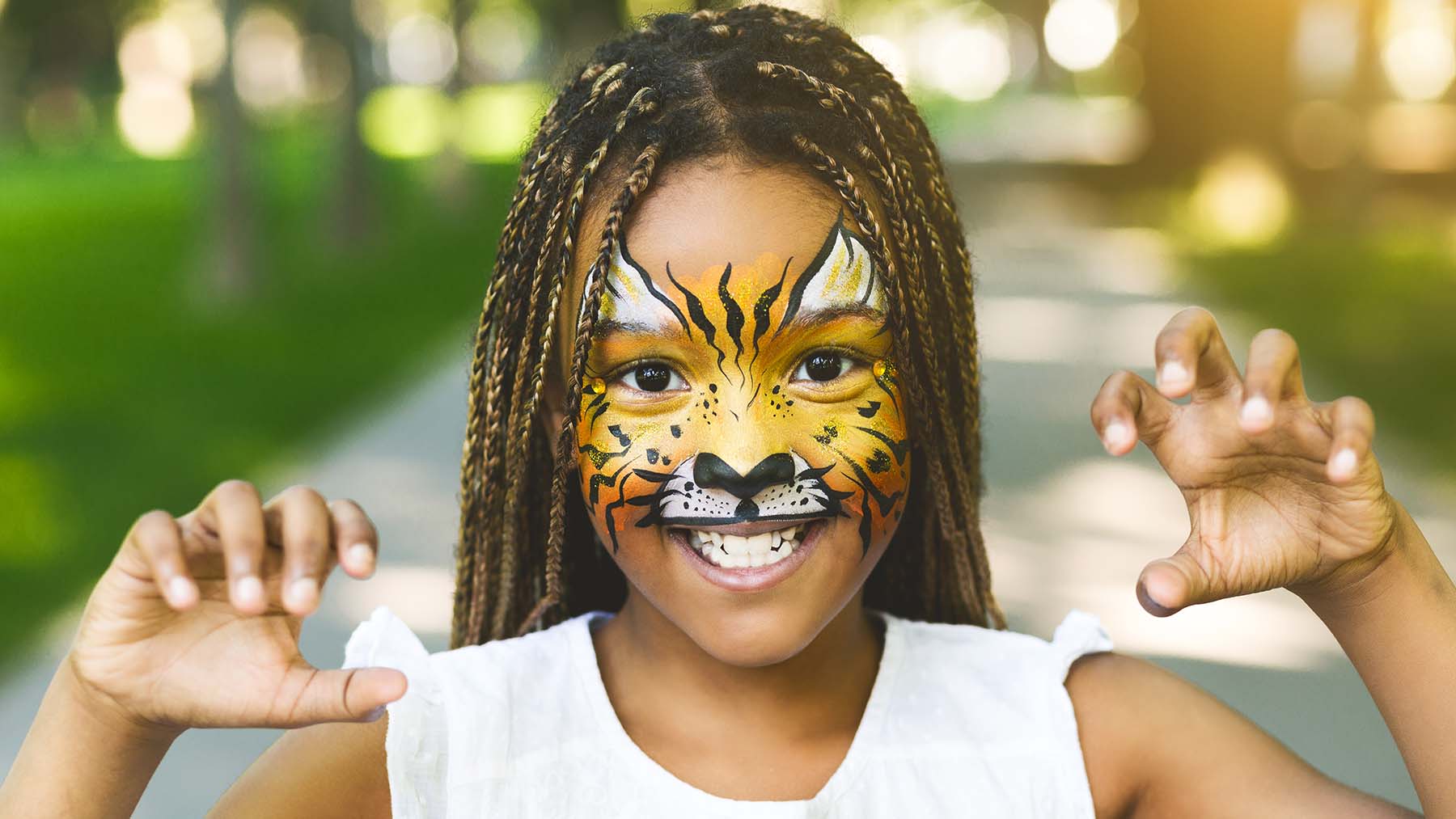 Young Black girl with halloween face paint