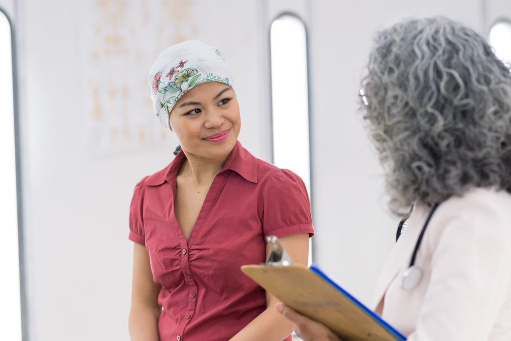 Female Cancer patient speaks with doctor