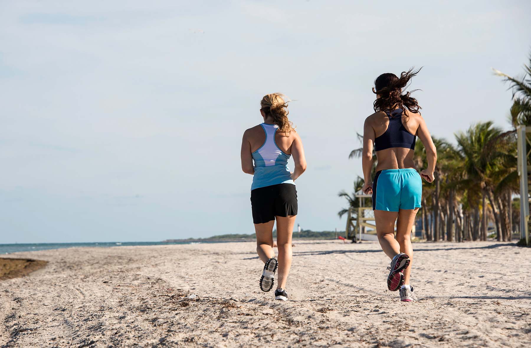 Two Women running on beach in Miami