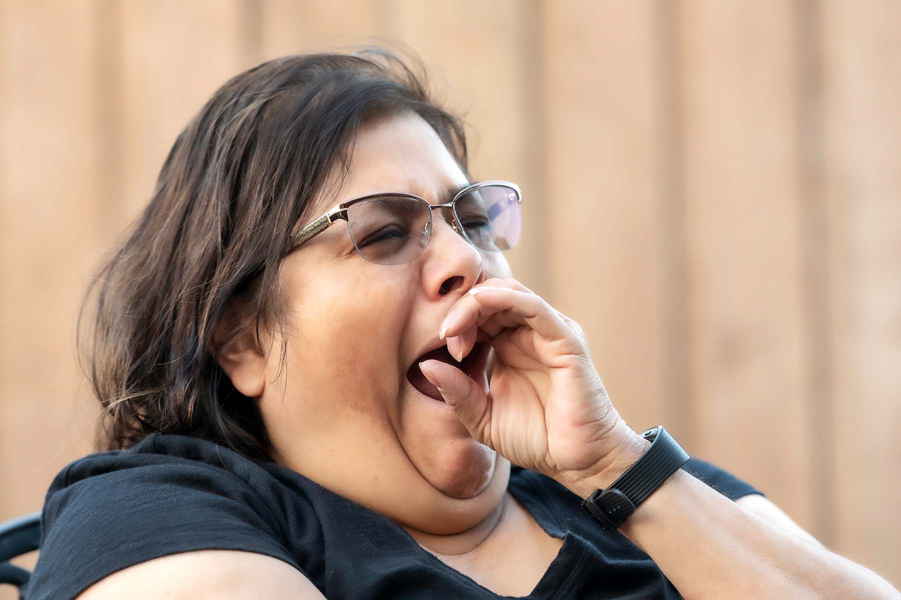 Heavyset Hispanic woman yawning