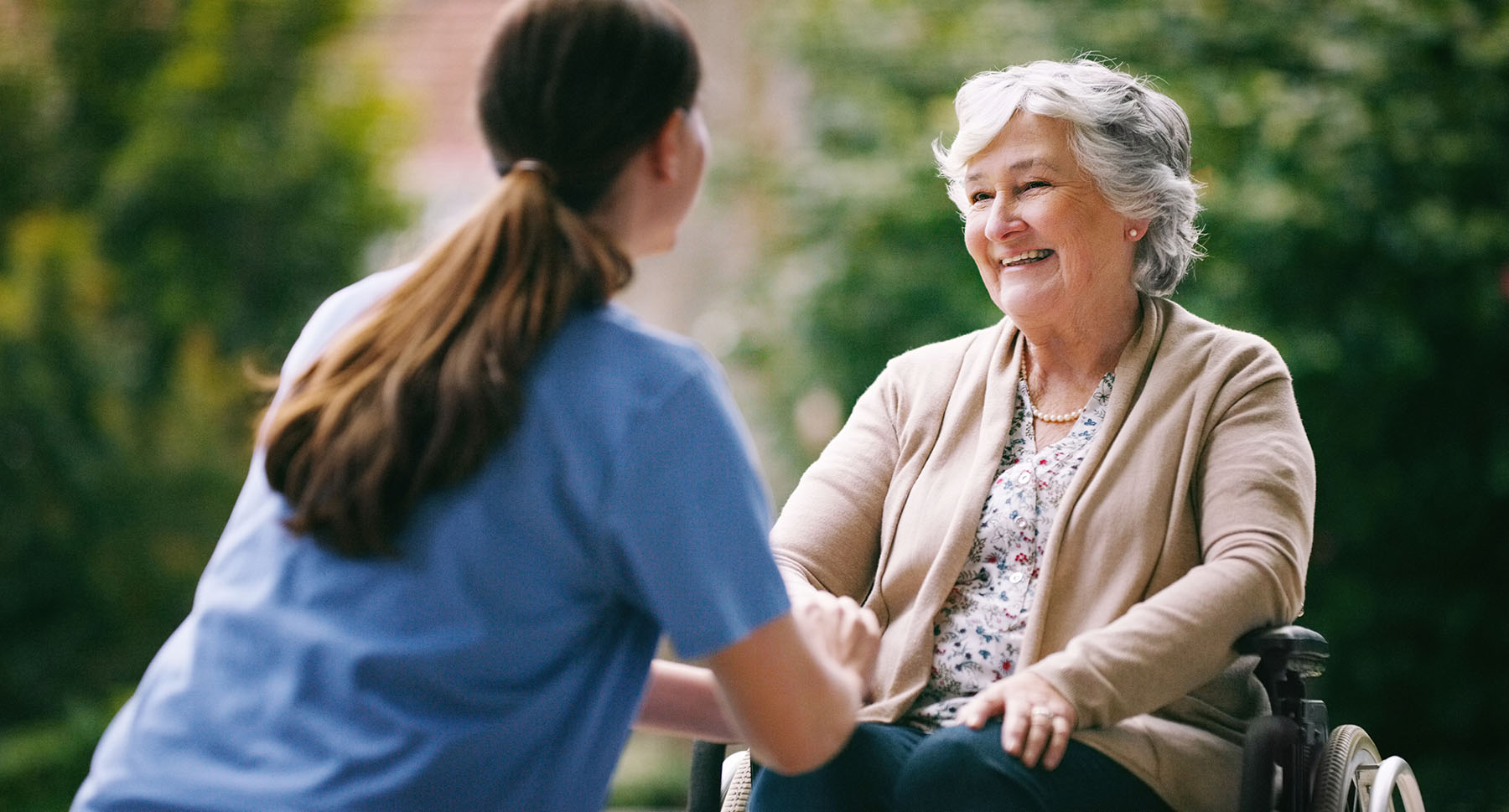 Nurse talking to elder woman outside