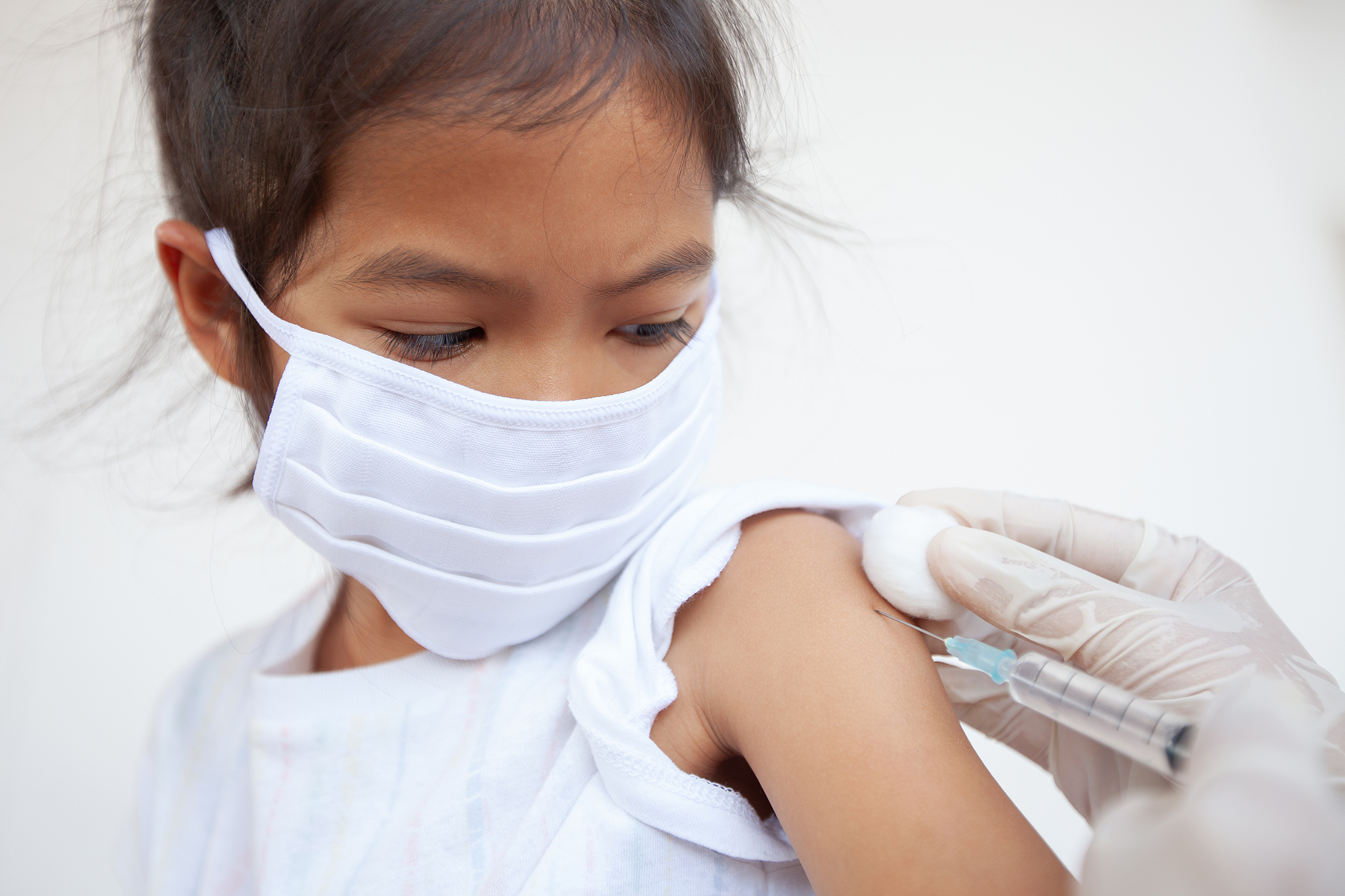 Child gets vaccine, COVID mask