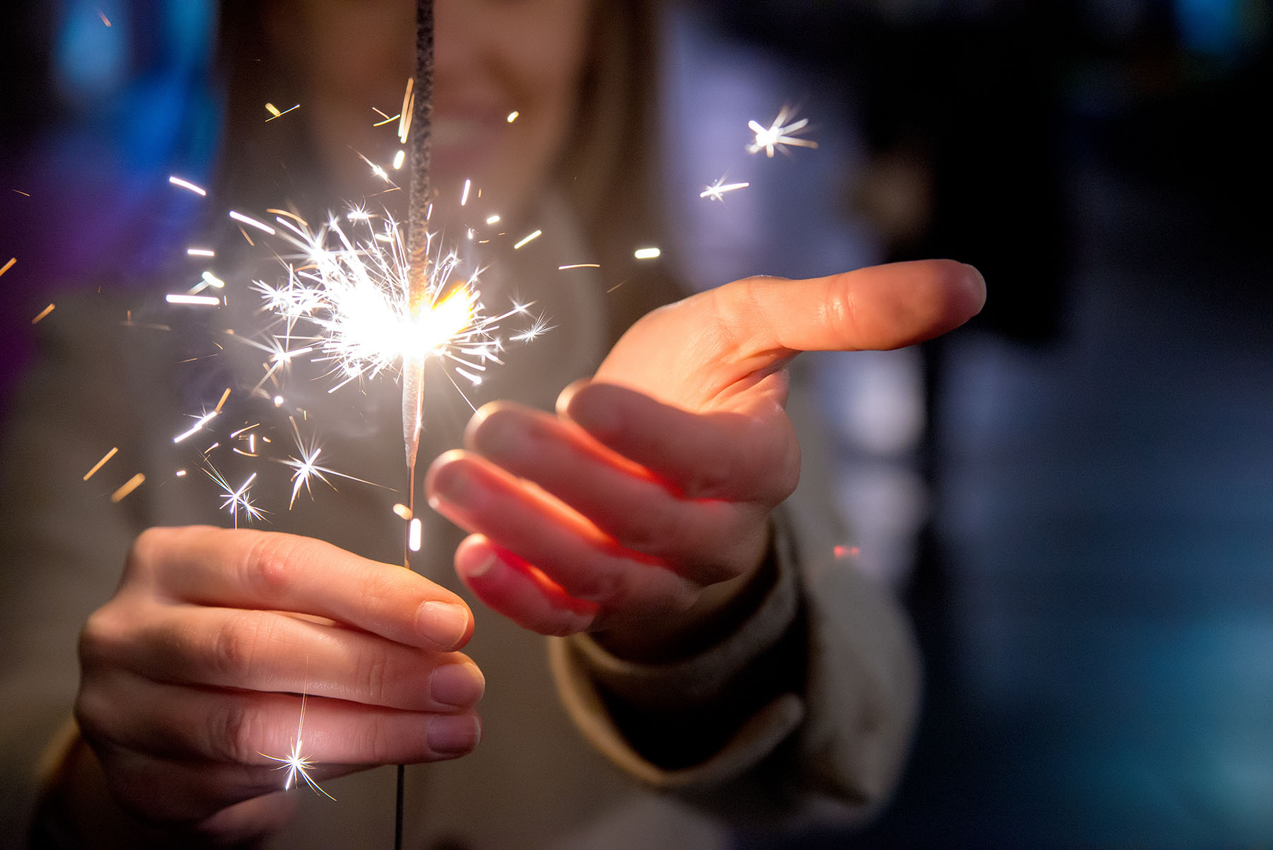 Woman holds sparkler firework