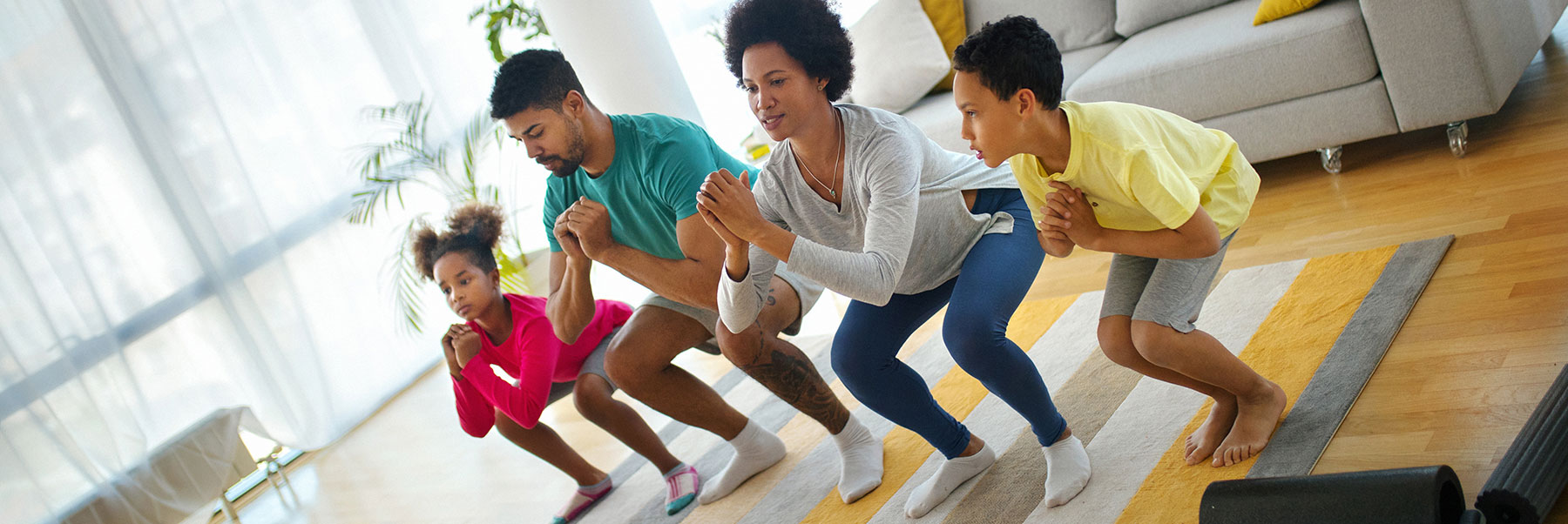 Family doing a power yoga pose together