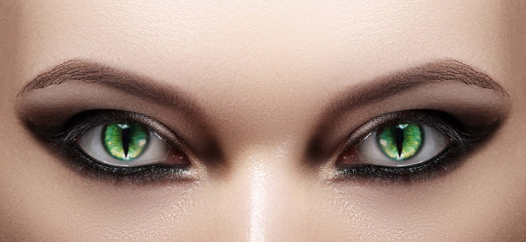 Close up of a face with Halloween cat-eye contact lenses