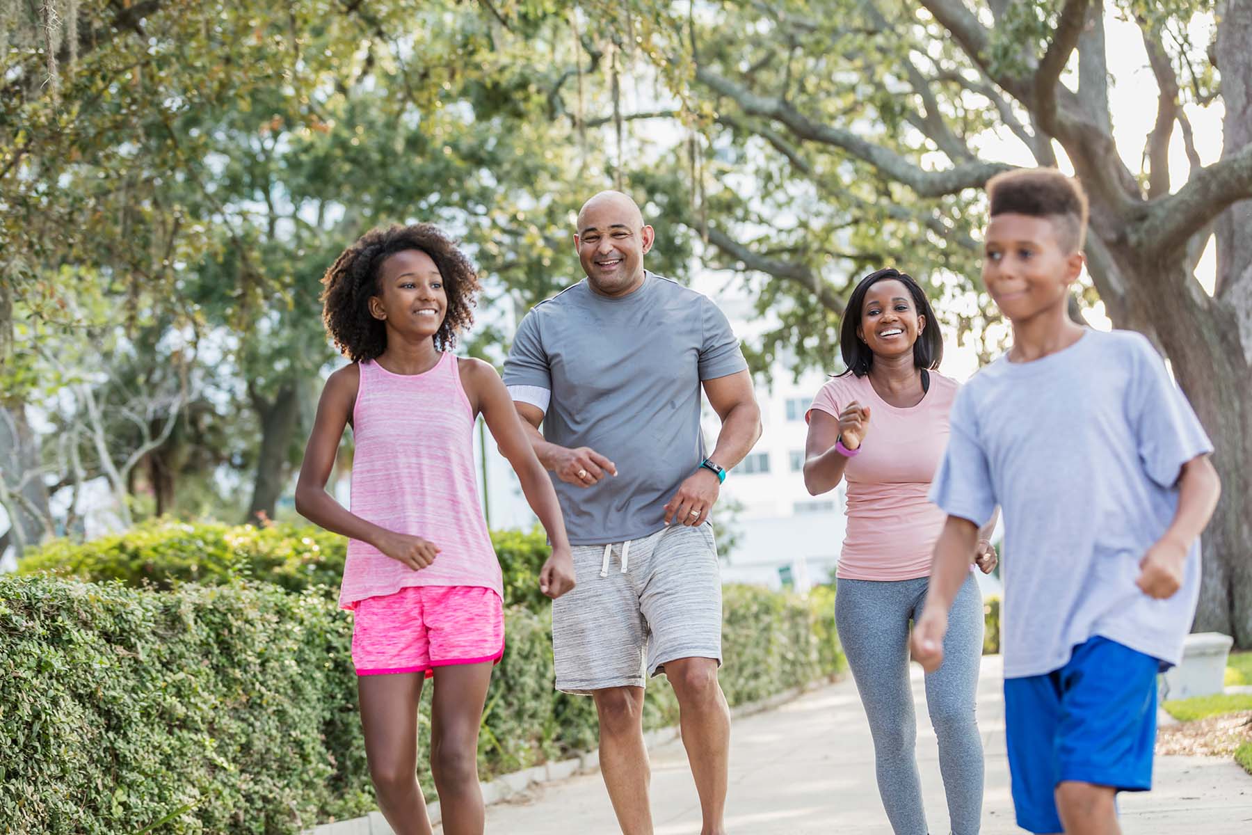 Happy Hispanic and African American family takes a walk at a South Florida park.