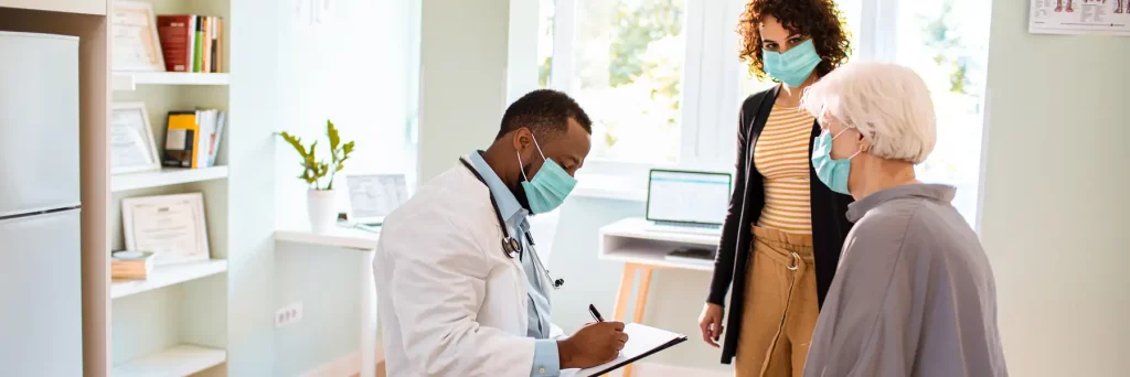 Close up of a senior woman and her daughter at a functional medicine appointment
