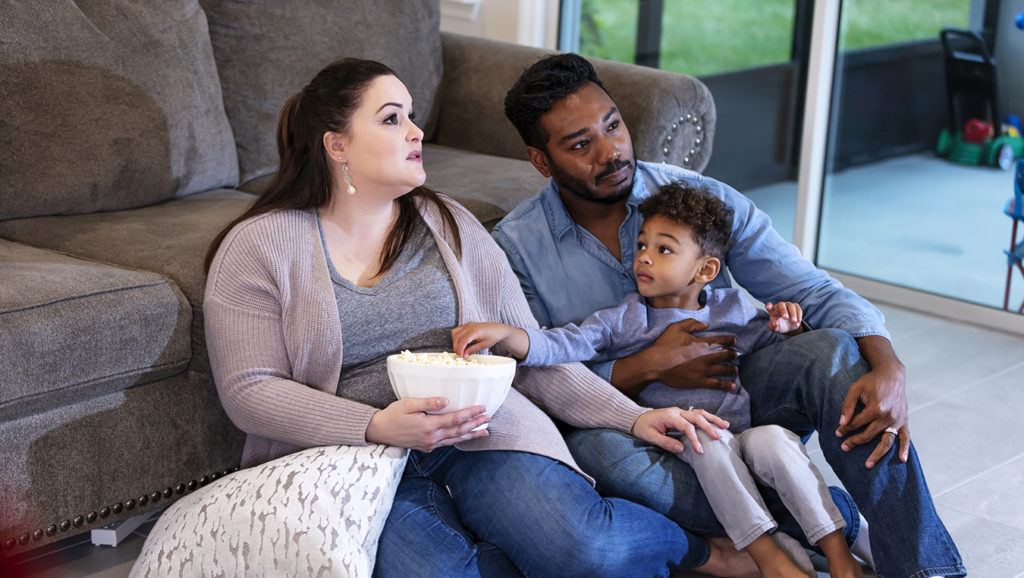 Family watching tv. Woman has endometrial cancer.