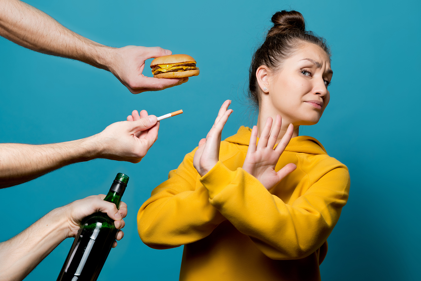Girl crosses arms to reject "bad habit" items wine, cigarettes, burger