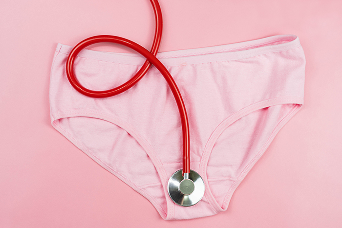 Pink underpants and red stethoscope isolated on pink background.