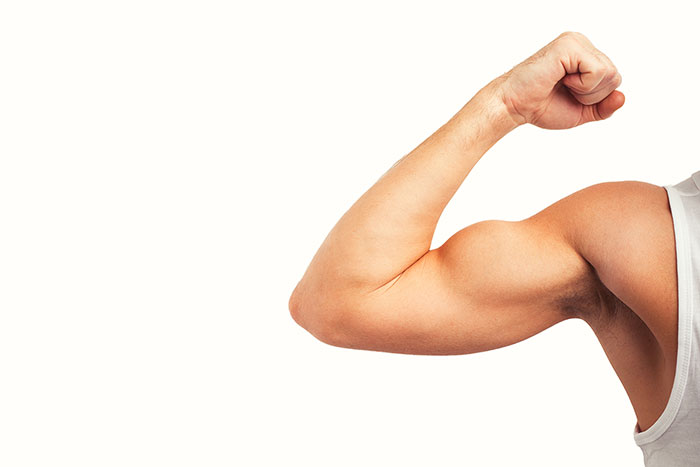 Photo of a man flexing big bicep muscles.