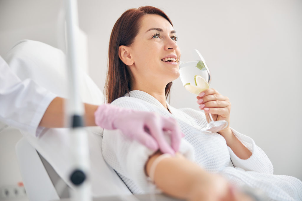 woman enjoying IV vitamin drip at spa