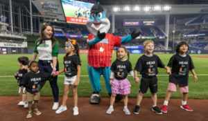 Cute young Childrens Hearing Program patients on mound for Marlins