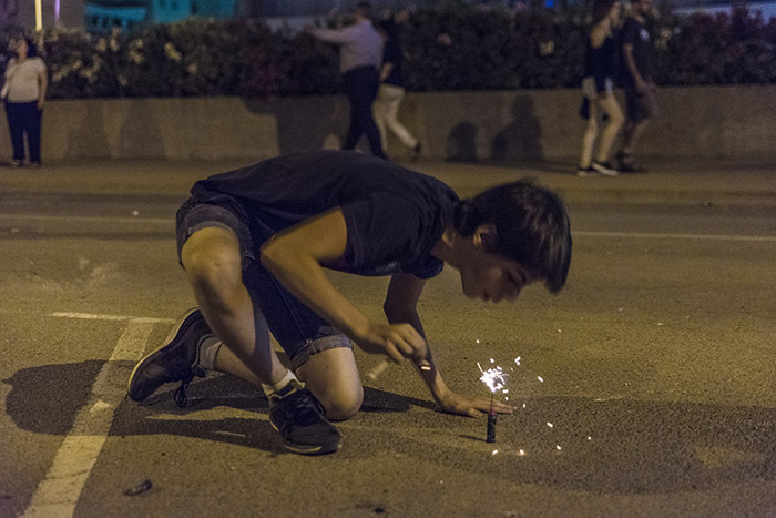 Boy exploding firecrackers at night