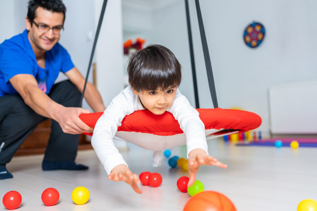 Child on swing in therapy session