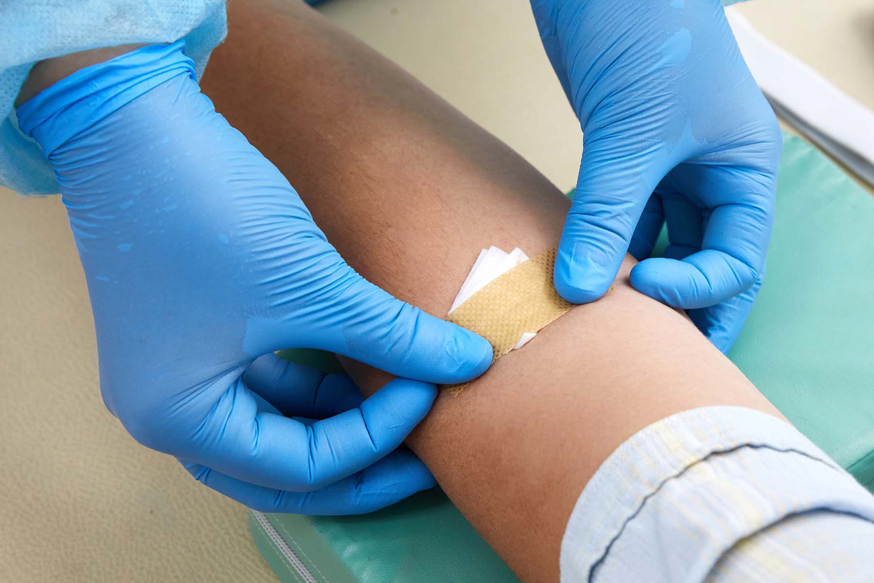 Nurse applies band aid after blood test