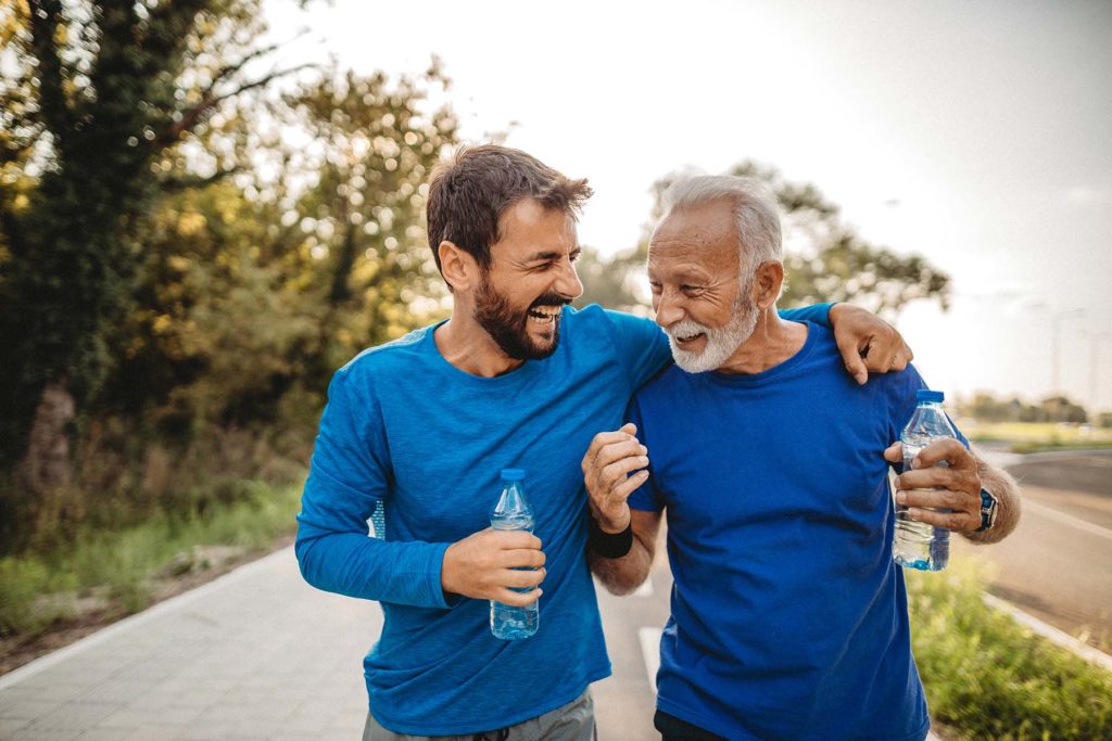 Two men in blue shirts walking for exercise