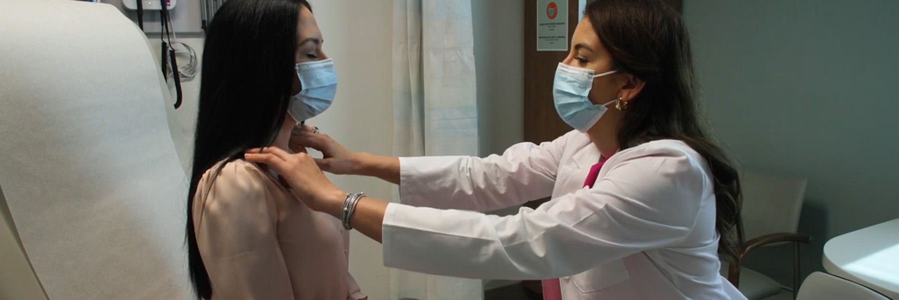 Female cancer patient receives hands-on medical care from a female doctor