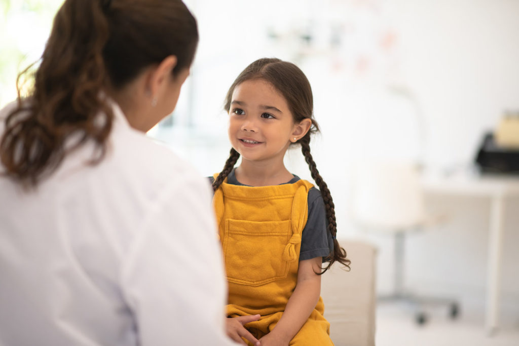 Pretty young Hispanic girl at doctor appointment.