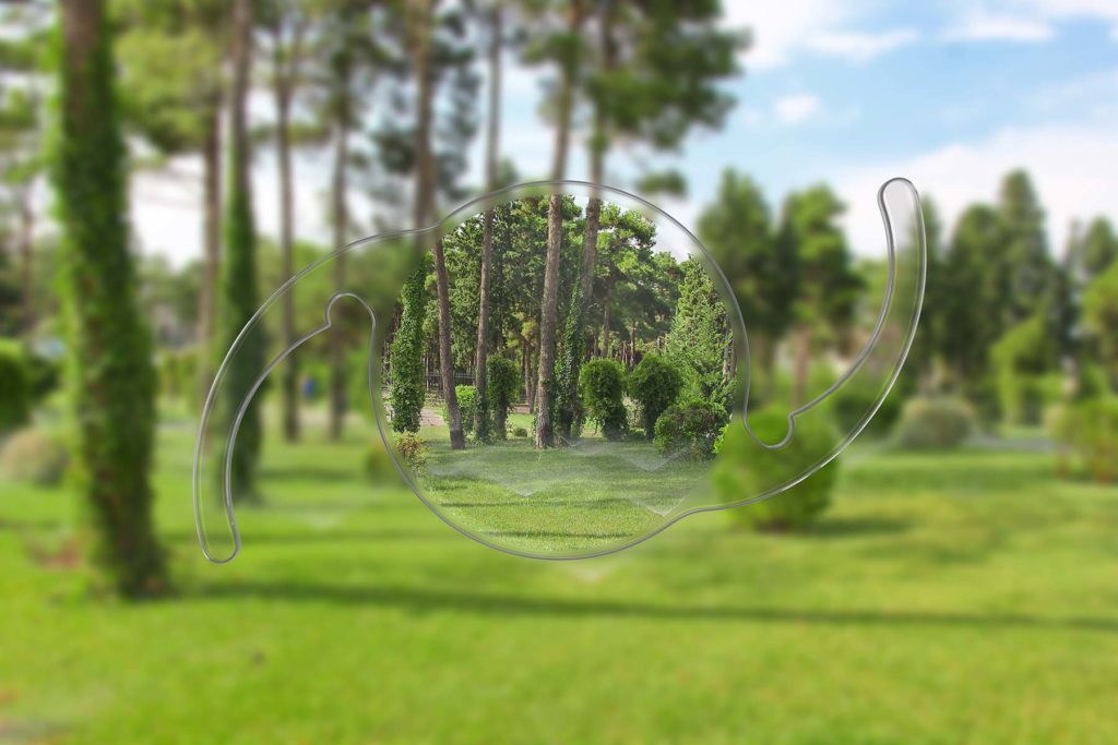 The clarifying view of an intraocular lens looking at an outdoor park.