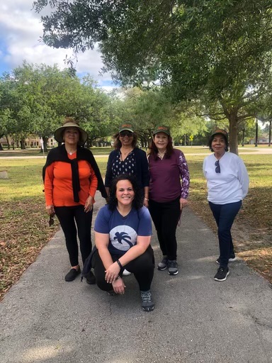 Elizabeth Soriano (kneeling, front), a "health promoter" who guides participants in a study being conducted by the University of Miami's Miller School of Medicine to help elderly Hispanics coping with depression and anxiety.