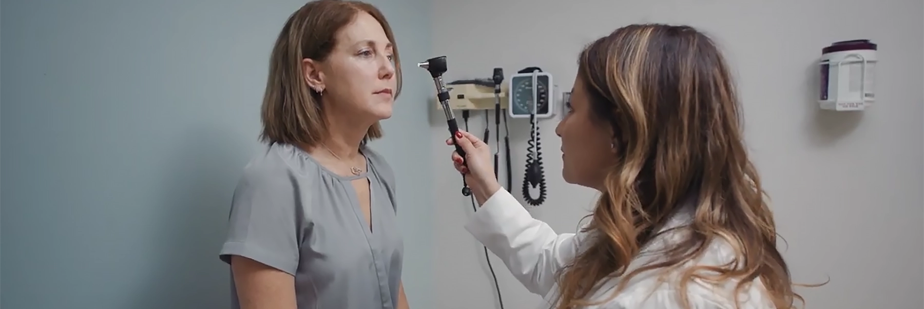 doctor examines woman who has had a stroke