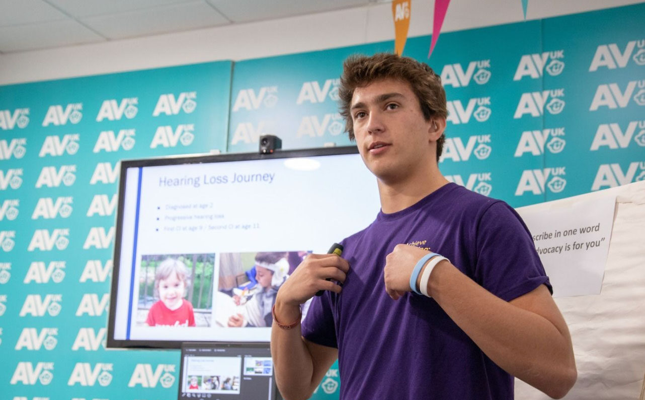 Teen with cochlear implants presents to an audience.