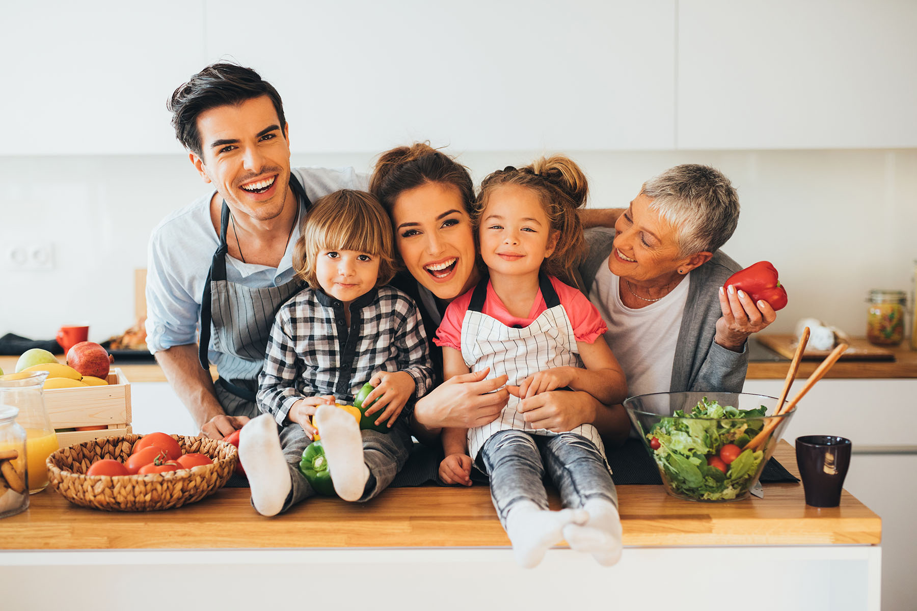 Smiling family in the kitchen with healthy food.