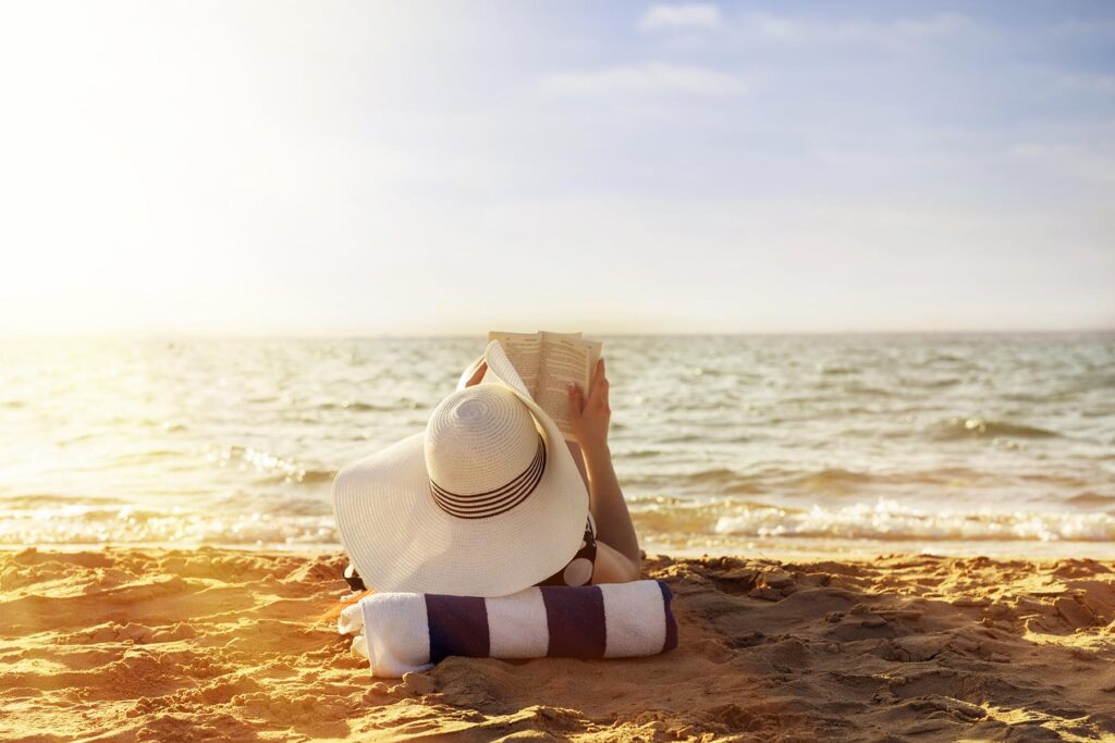Woman reads at the beach.