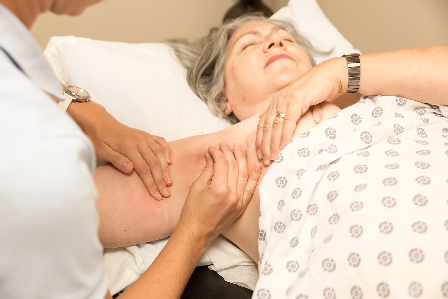 Mature woman getting her lymphedema checked by a doctor.