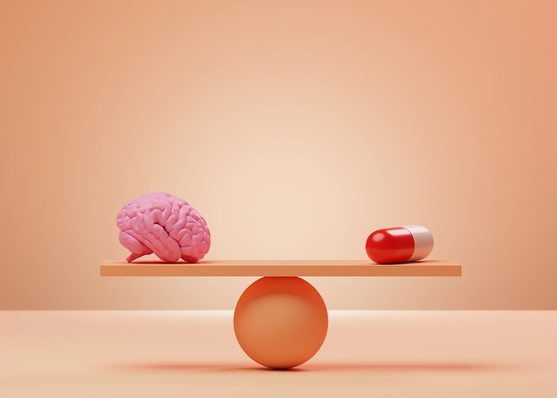 Brain and oversized pill on either side of a seesaw to illustrate the placebo effect