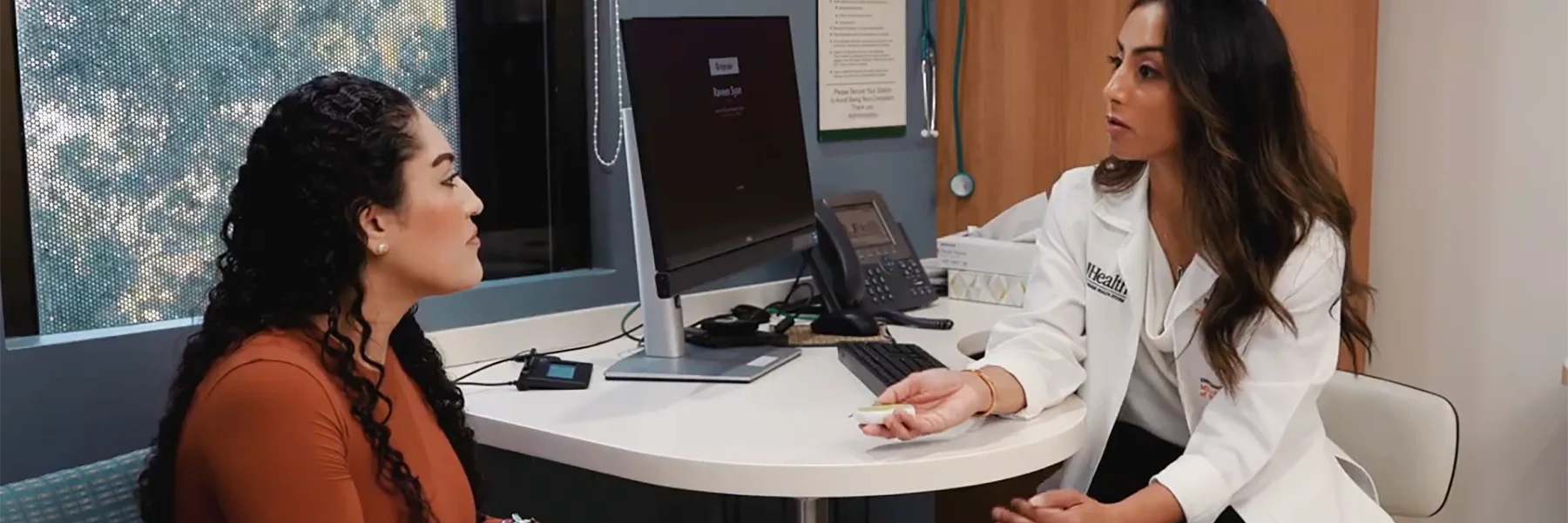 doctor explains overactive bladder device to patient