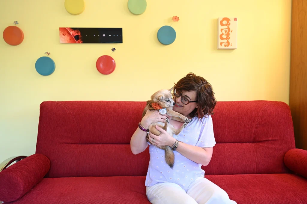 Rochelle cuddles with her dog, Olive, who helped her get through cancer treatment.