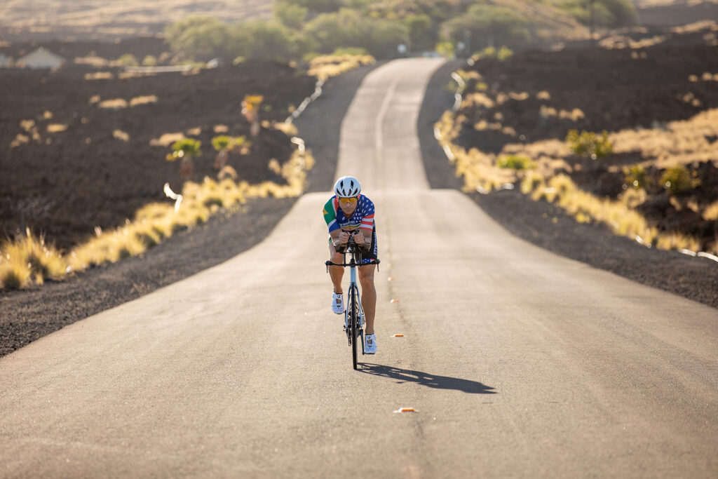 Triathlete Michael Atkinson, biking on a country road