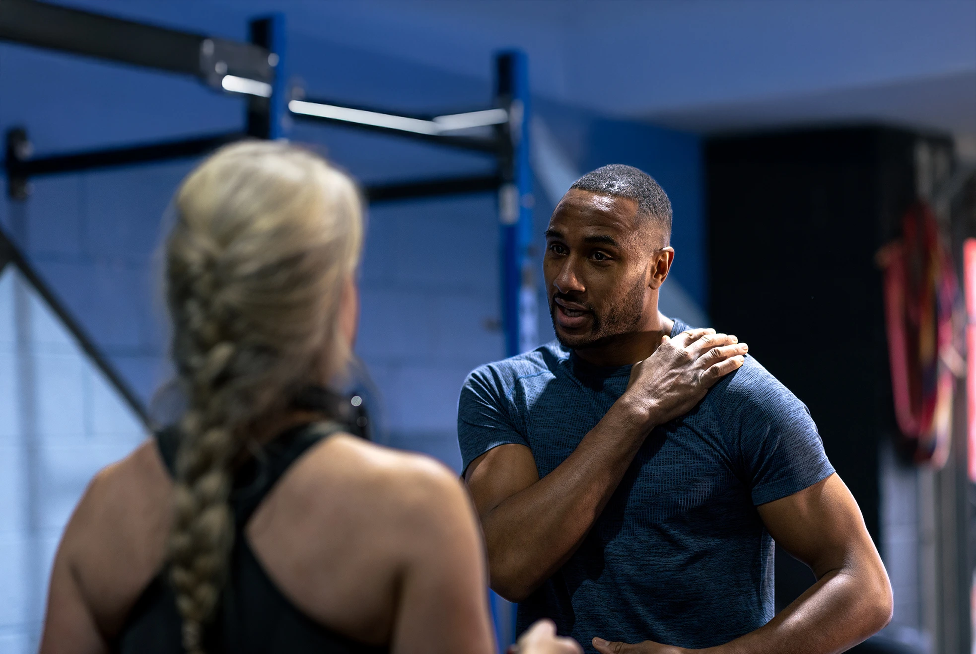 Strength trainer discusses options with athlete.