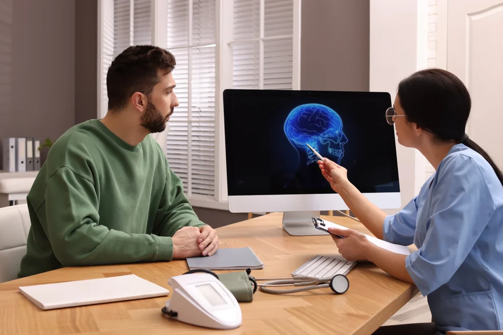 Patient talks to neurologist about his diagnosis of epilepsy.