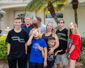 Fun family photo of the Loy family, making silly faces. 